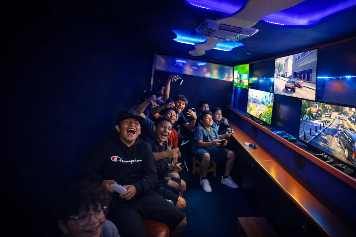 Guests playing multiplayer games inside a Capture Entertainment game truck in Orange County