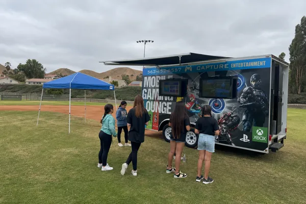 Students gathering at Capture Entertainment's Game Truck during a Southern California school event