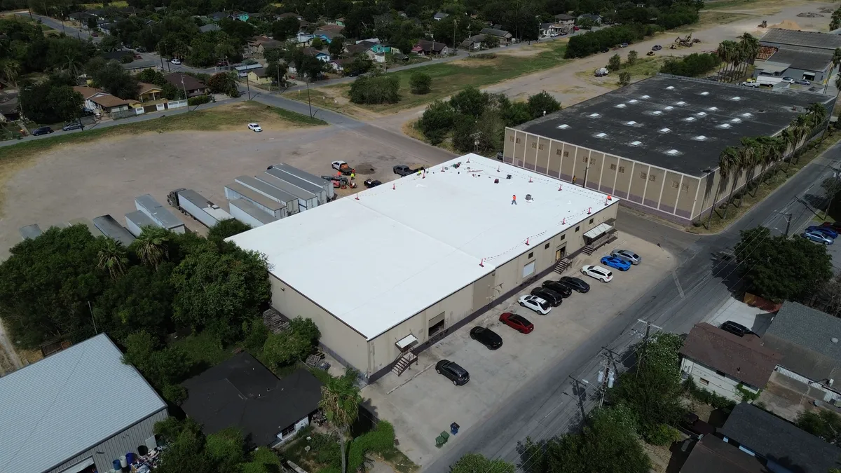 TPO commercial roof installation on a warehouse in Brownsville, Texas