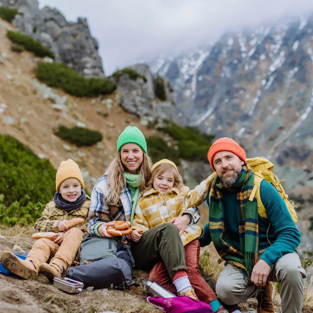 Children on ground holding hands in a circle representing community in Autism