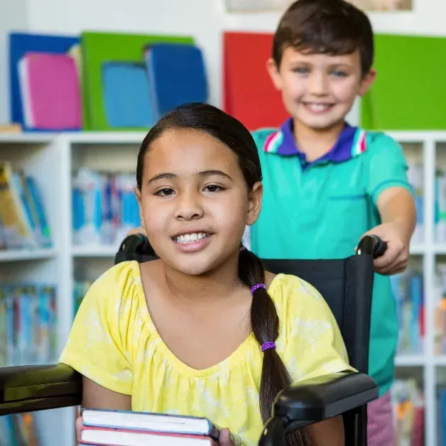 Children on ground holding hands in a circle representing community in Autism