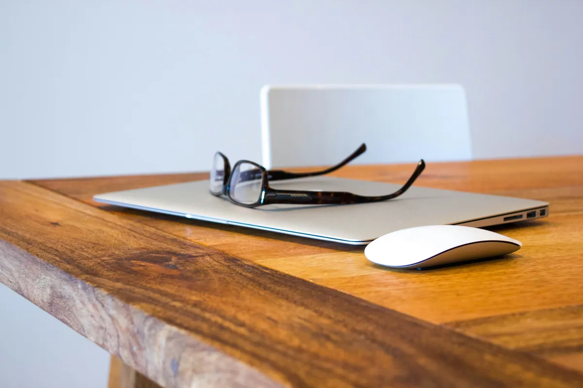 A closed laptop left on an office desk at the end of the day, representing taking work email off your phone