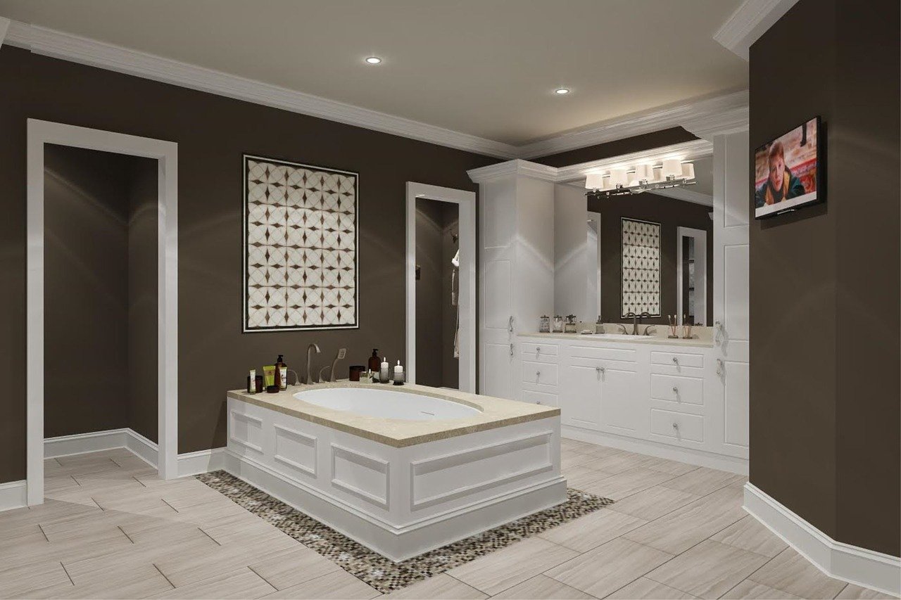 Luxury master bathroom with freestanding soaking tub, custom white cabinetry, double vanity, recessed lighting, and neutral tile flooring
