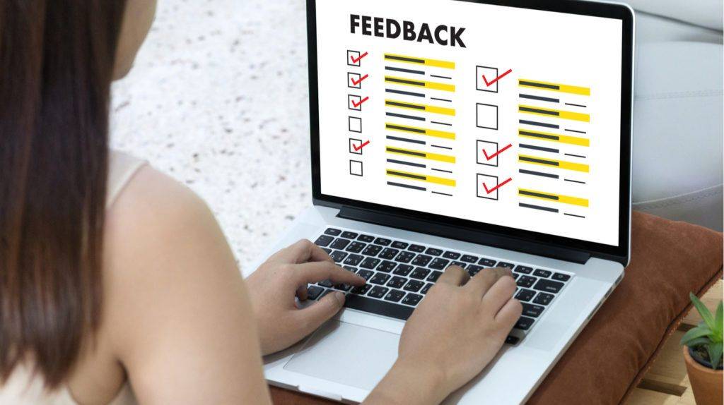 Professional completing an online 360 feedback survey on a laptop as part of the ALC People Solutions assessment process.