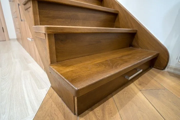Beautiful hardwood stairs with built-in storage drawers highlighting Custom Carpentry Creations in Clovis and space-saving design.