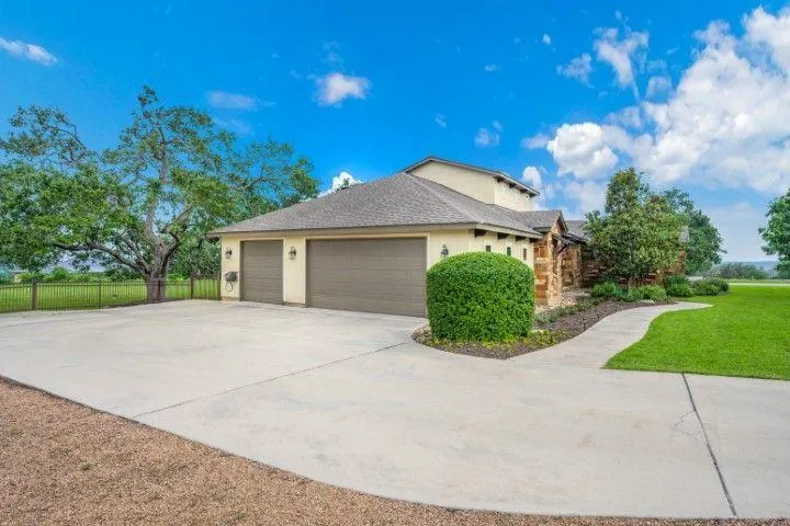 A wide concrete driveway and walkway outside a modern home, installed by a concrete contractor in Dania Beach FL.