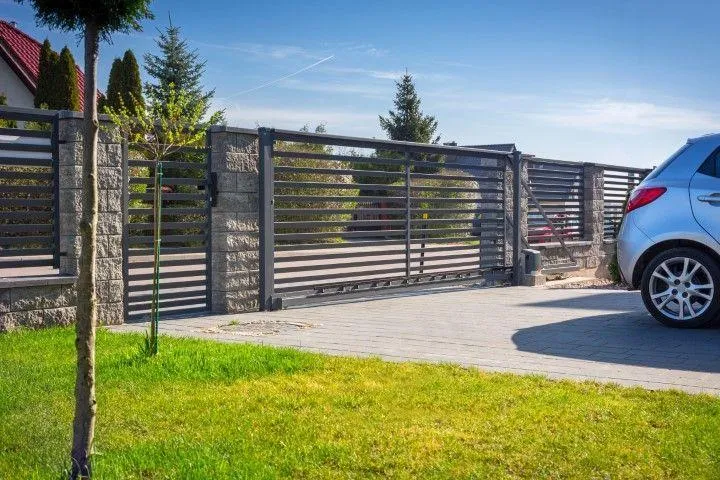 A sleek modern metal sliding driveway gate installed by Paso Robles Fencing Pros, in Paso de Robles CA.