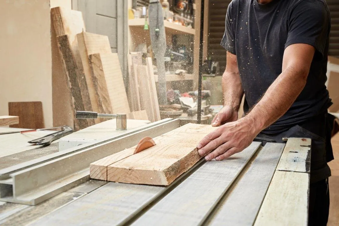 Craftsman cutting wood on a table saw, provided by Fort Washington Carpentry Craftsmen in Fort Washington, MD