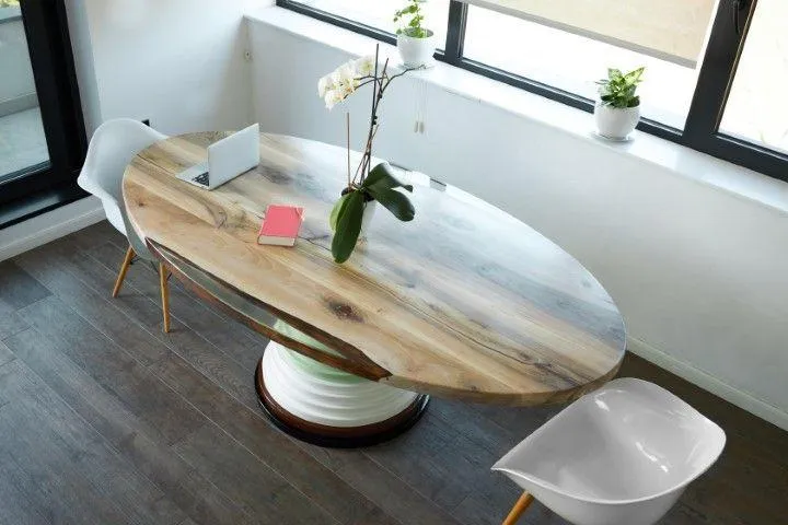 Wethersfield Carpentry Masters in Wethersfield CT modern oval wooden dining table with white chairs.