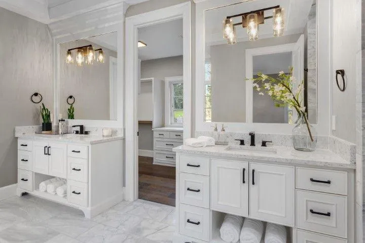 Wethersfield Carpentry Masters in Wethersfield CT custom white double bathroom vanities with dark hardware.