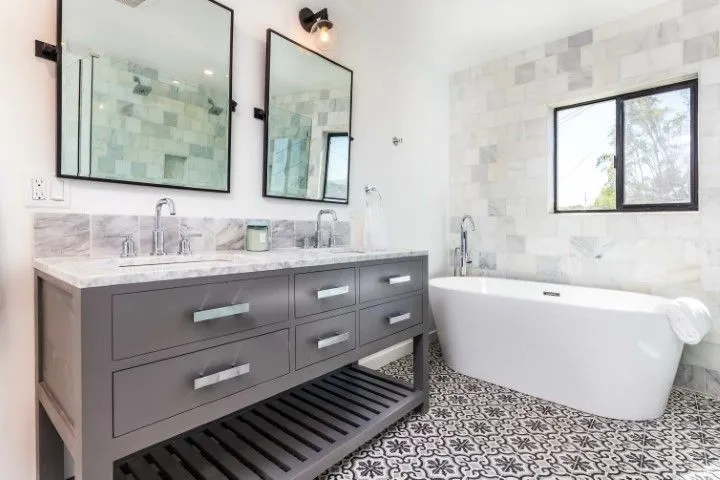 Beautifully renovated bathroom featuring a custom grey vanity, vessel sinks, and a freestanding tub by Custom Carpentry Creations in Clovis.