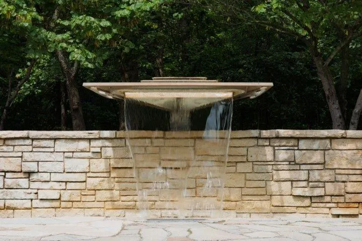 Clarington Masonry Craftsmen in Clarington ON showcasing a modern stone retaining wall water feature.