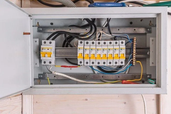 Falls Electric Services Company in Falls PA servicing an open circuit breaker panel with wires.