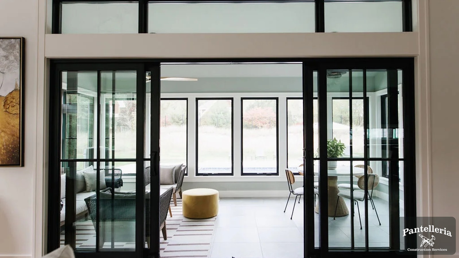 Open black-framed sliding doors dividing a finished Southwest Michigan living space from the rest of the home during a remodel