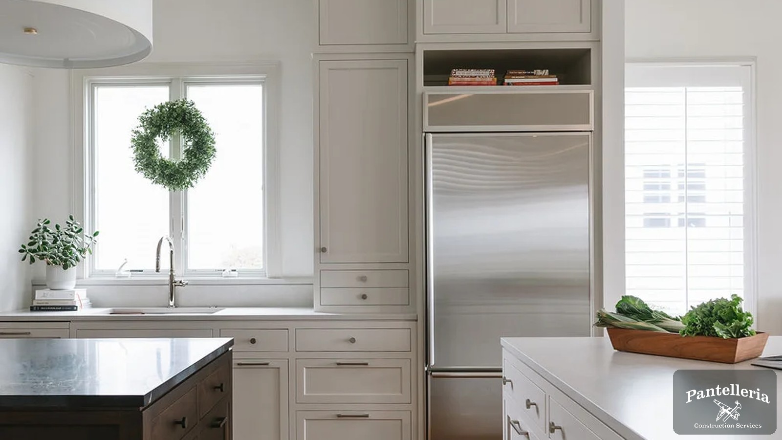 Custom kitchen with painted cabinetry, a dark stained island and hardwood floors in a Southwest Michigan custom home