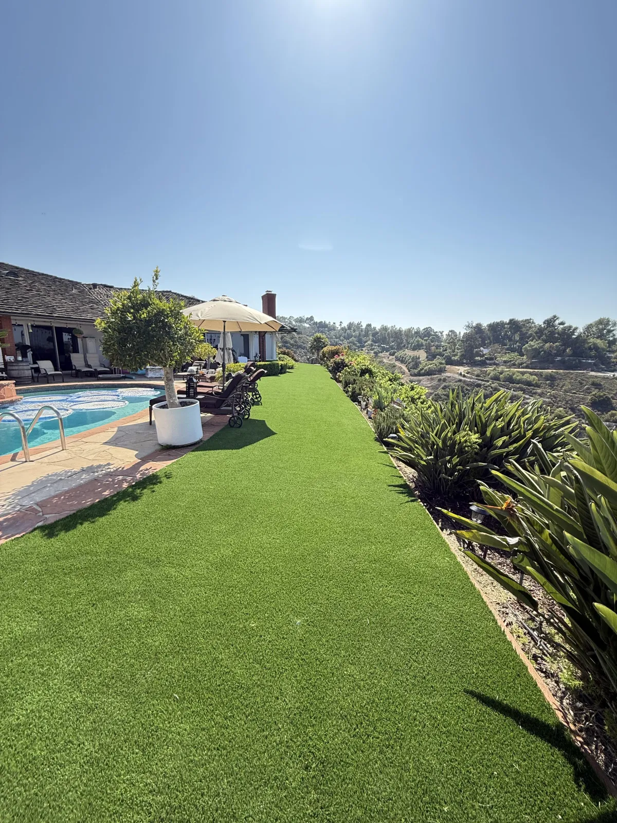 Artificial turf installed around pool area by Liberty Landscape & Construction in Ventura County, CA — clean and low-maintenance lawn design.