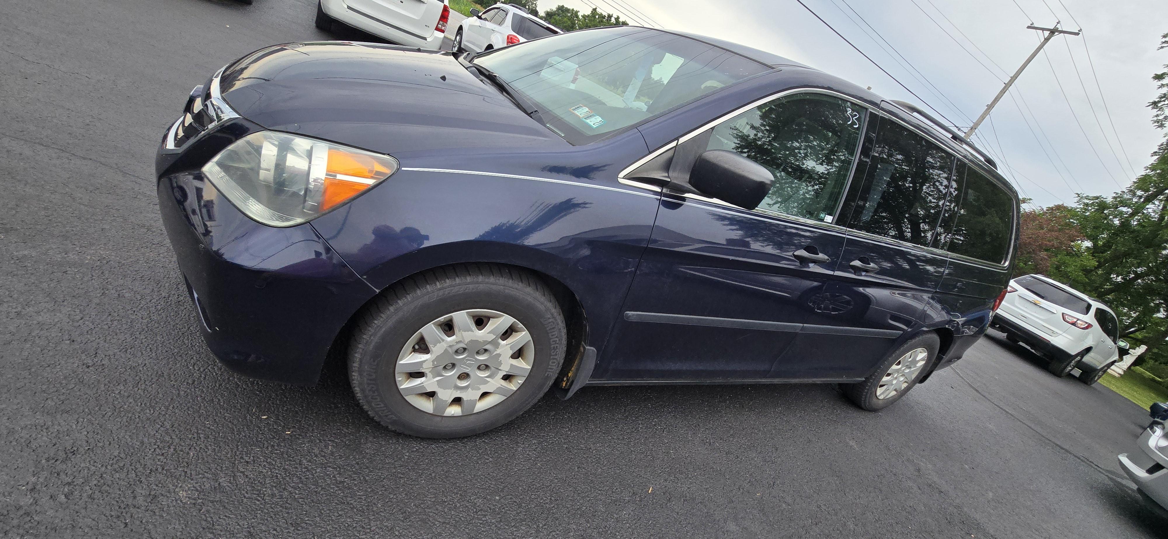 Blue 2008 Honda Odyssey LX parked in driveway, grey interior visible