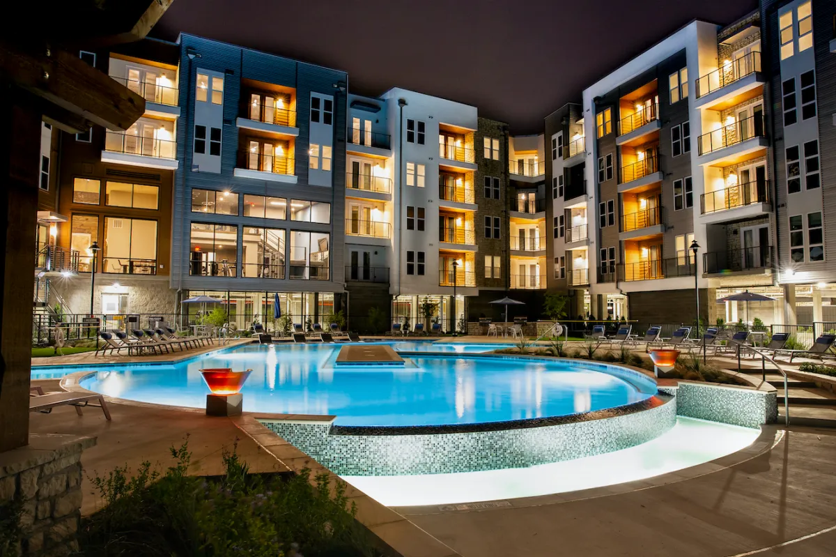 gray concrete tower building under blue and white sky