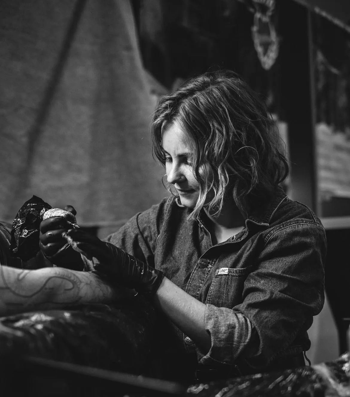 person in blue denim shorts and white nike sneakers standing on gray concrete floor