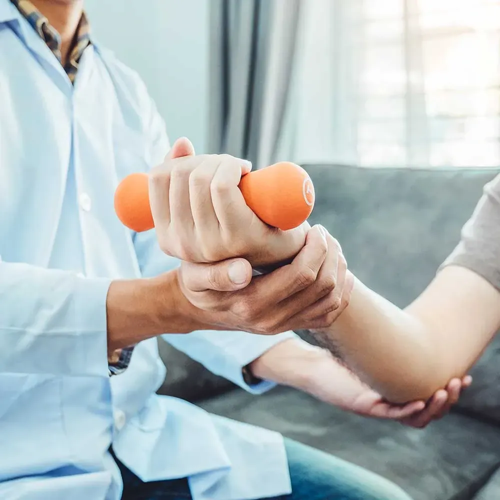 physical therapist helping with wrist and hand pain recovery therapy at 903 Physical Therapy in whitesboro, texas