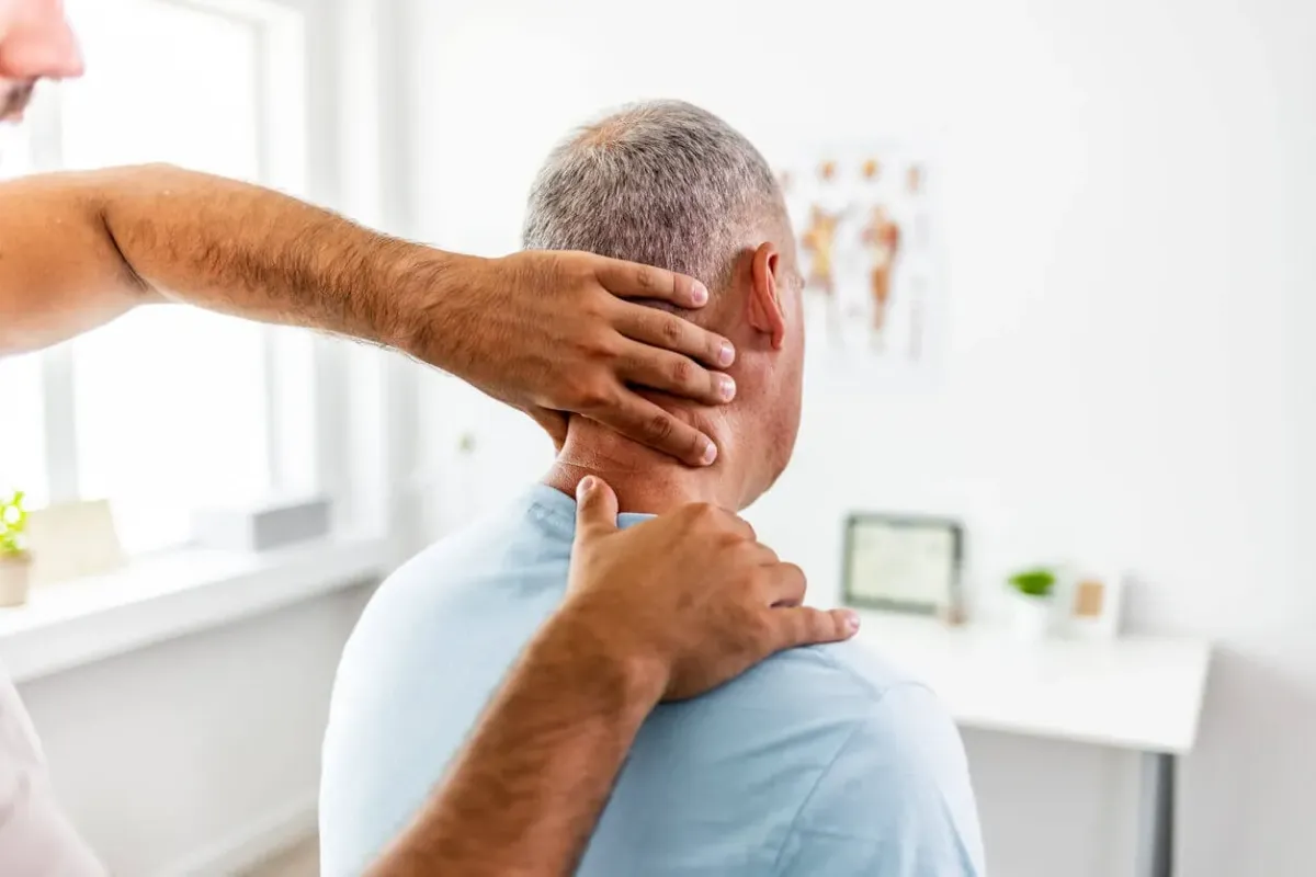 physical therapist helping guy with office ergonomics therapy at 903 Physical Therapy in whitesboro, texas