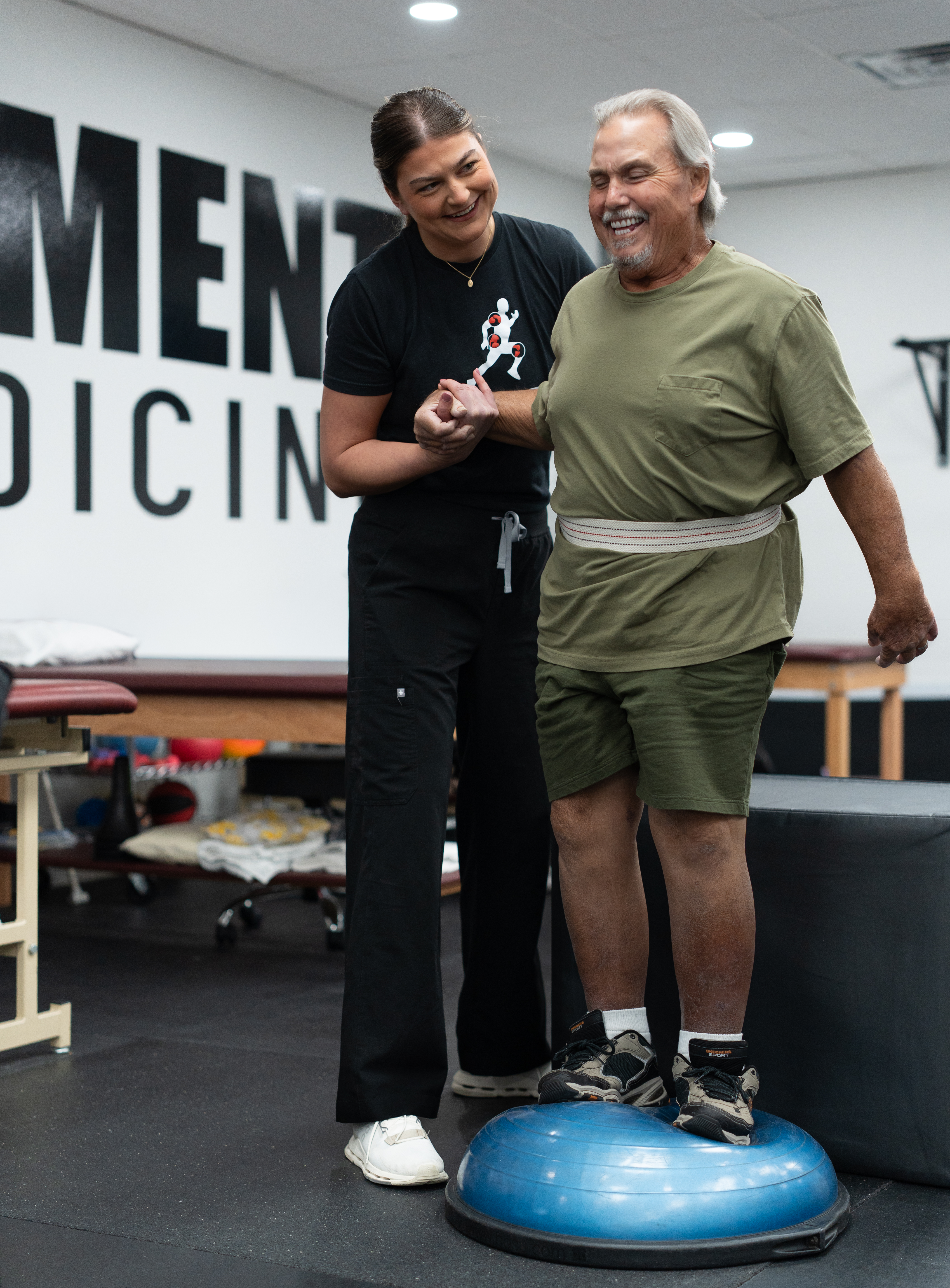 physical therapist helping guy with stroke rehab therapy at 903 Physical Therapy in whitesboro, texas