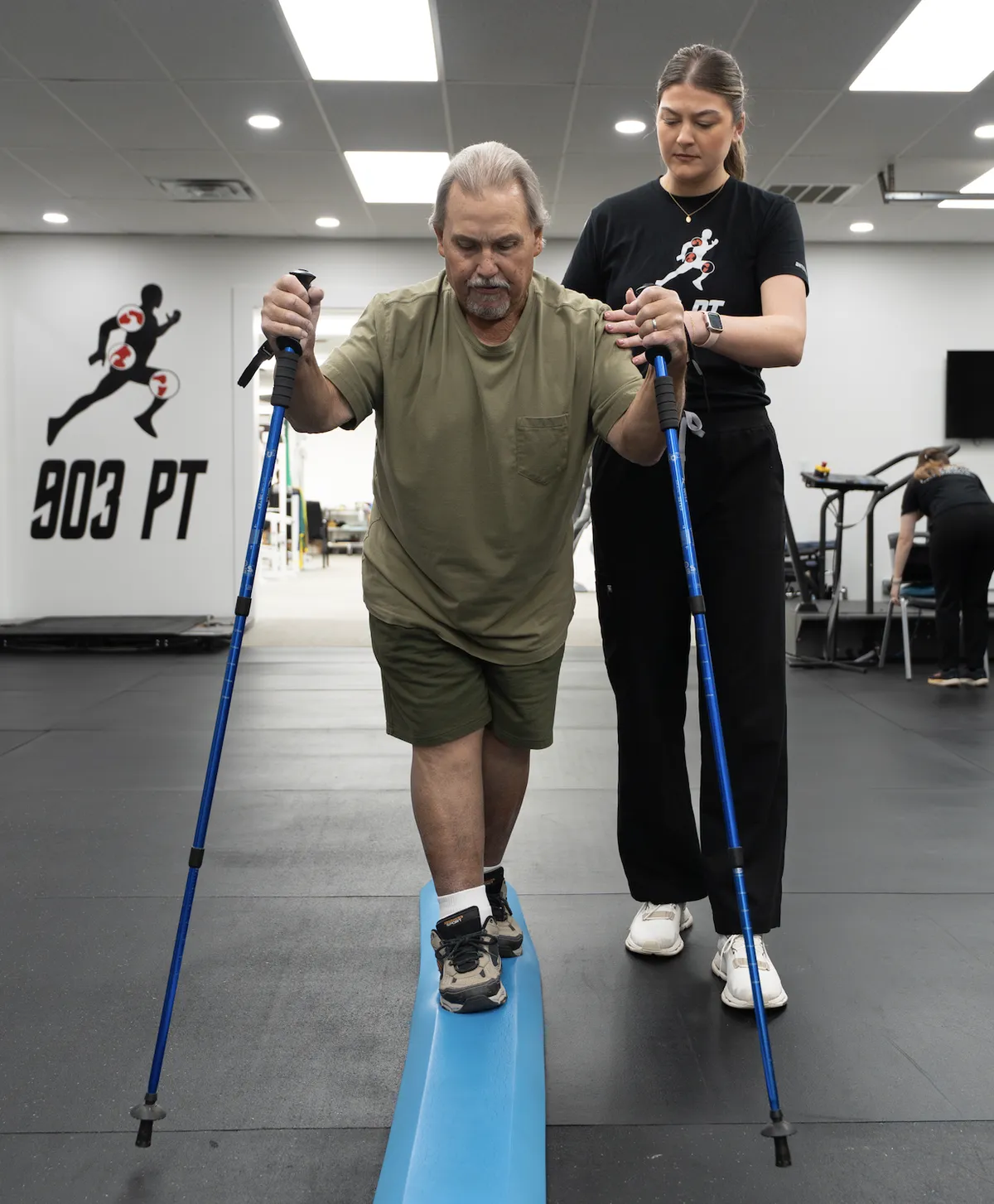 Physical therapist helping a patient with balance training after surgery at 903 Physical Therapy in Gunter, TX