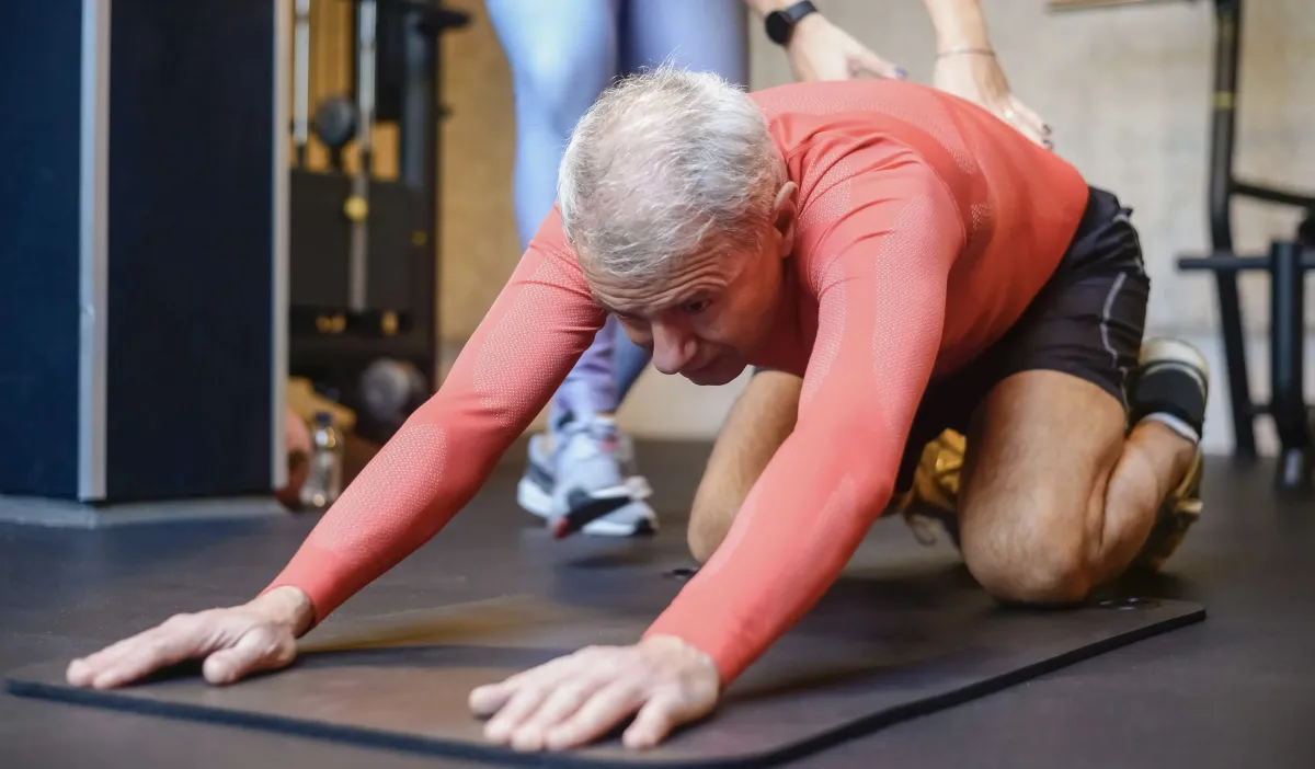 physical therapist helping guy with arthritis pain through therapy at 903 Physical Therapy in whitesboro, texas