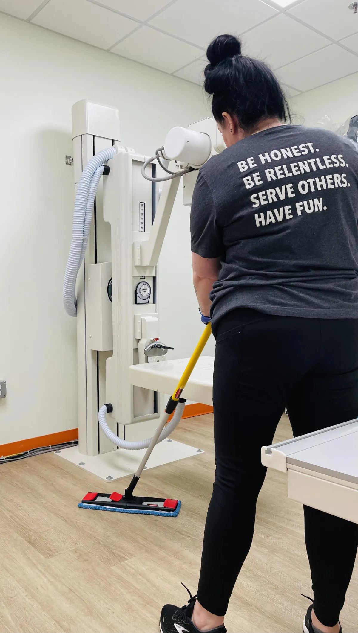 Cleaning a medical facility with a microfiber mop.