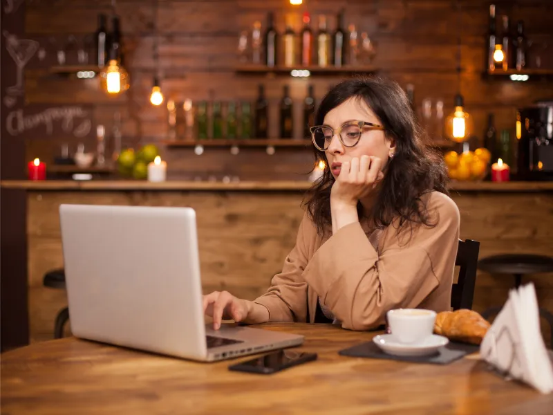 woman with laptop in coffee shop