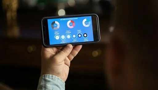 Close-up of a person using a food delivery app on a smartphone, browsing healthy meal options like vegan, salad, and pasta.