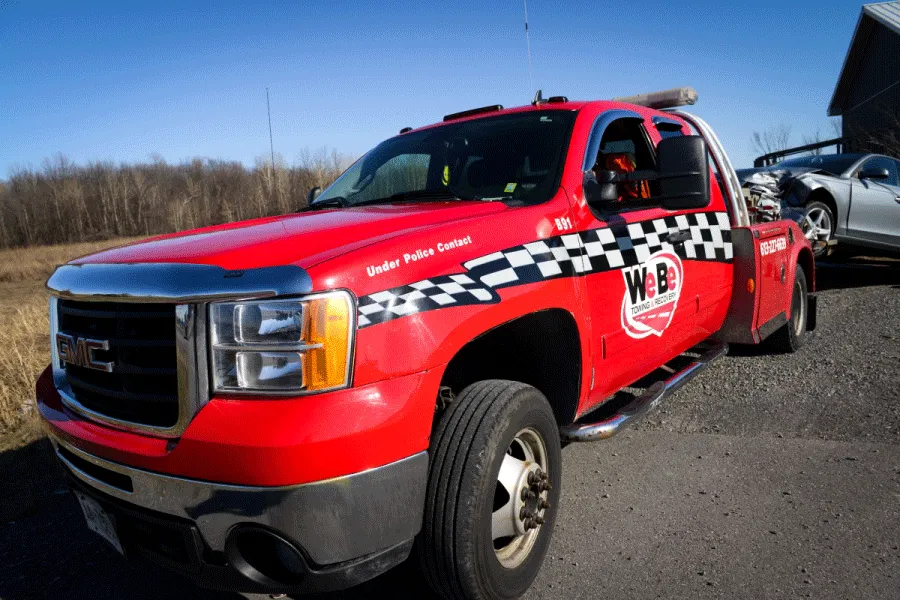 A rusty blue truck sits alongside the road.