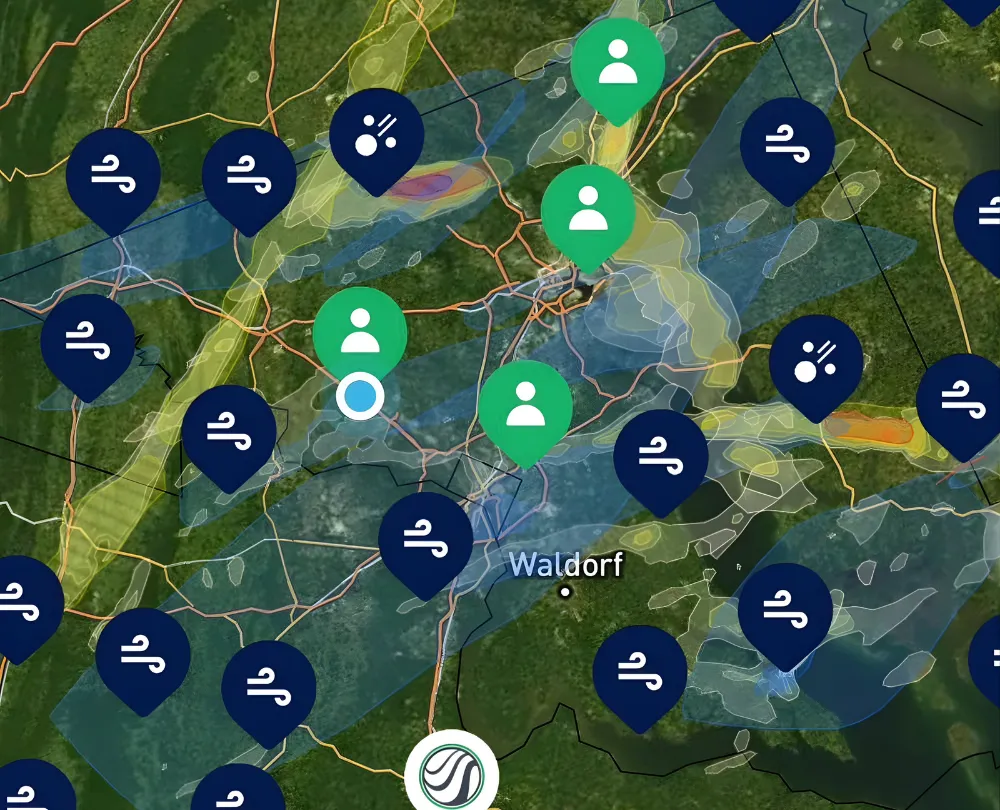 A bird sitting on top of a roof next to a building