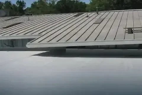 Low-slope TPO membrane roof alongside metal panels on building in Woodbury