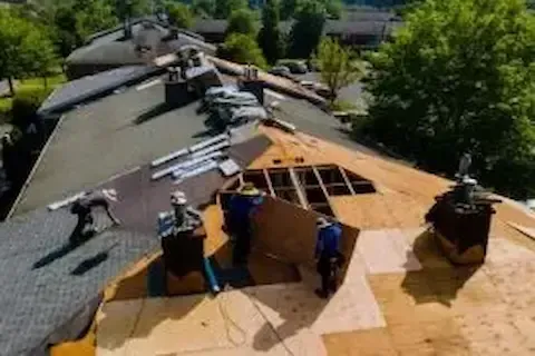 Aerial view of full roof replacement underway on a multi-family home in Woodbury by Woodbury Roofing Pros