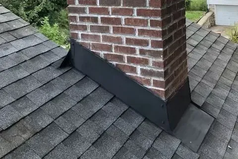 Fresh chimney flashing repair on brick chimney with asphalt shingle roof in Woodbury