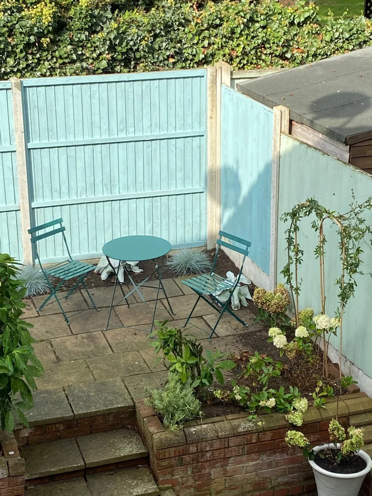 The courtyard garden with the rest of the fence panels painted