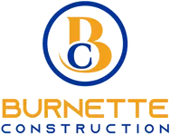 Burnette Construction team standing in front of a completed commercial building