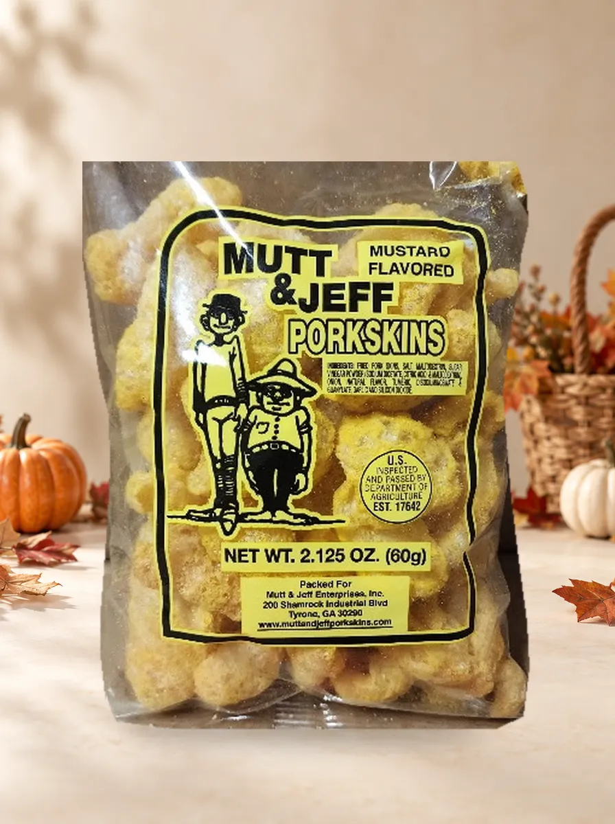 Clear plastic bag of 'Mustard' flavored pork skins with the Mutt & Jeff logo on a yellow label