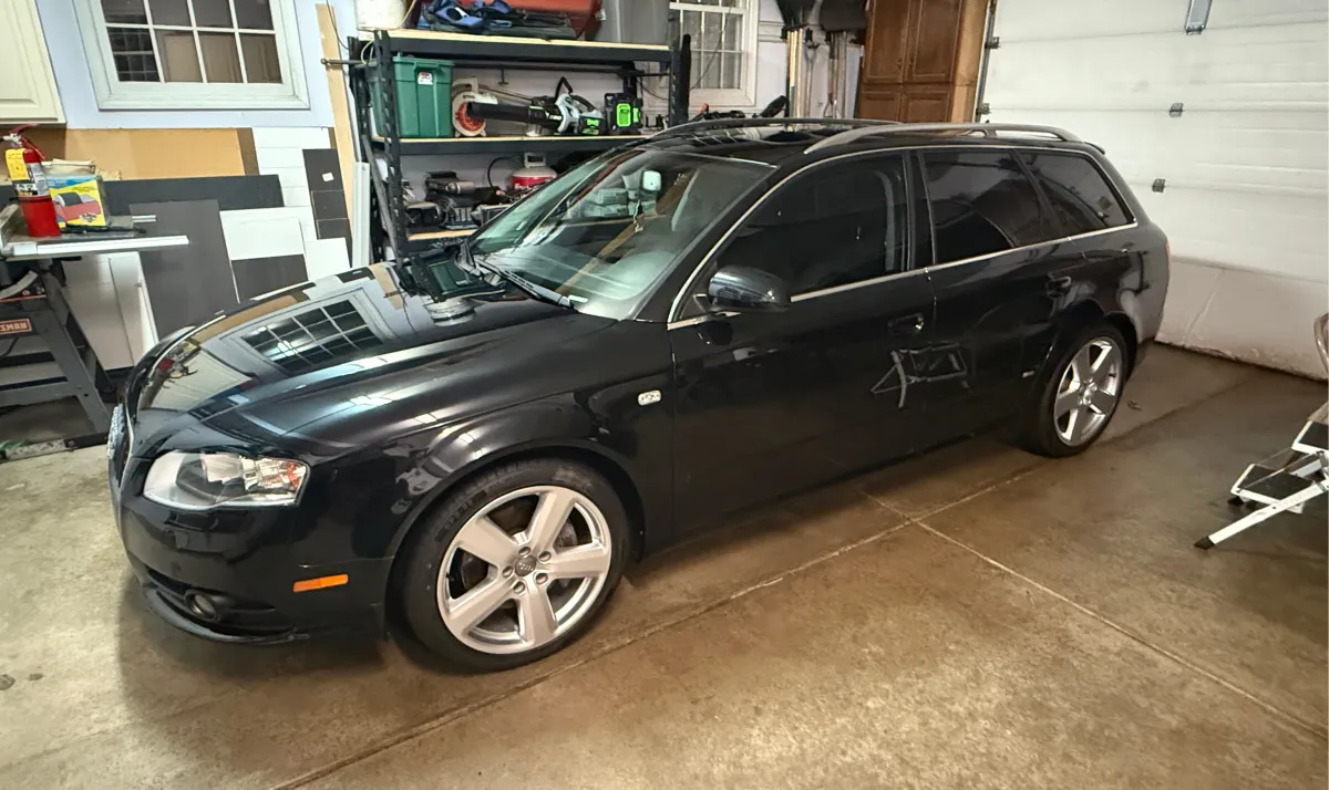 Black Audi luxury car with professional ceramic coating applied in Fall Creek WI for a high-gloss finish and advanced paint protection