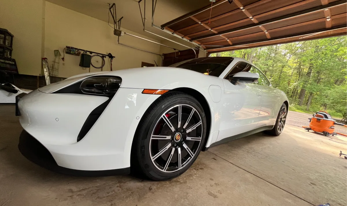 White Porsche Taycan electric car after ceramic coating service in Eau Claire WI enhancing shine and protecting paint
