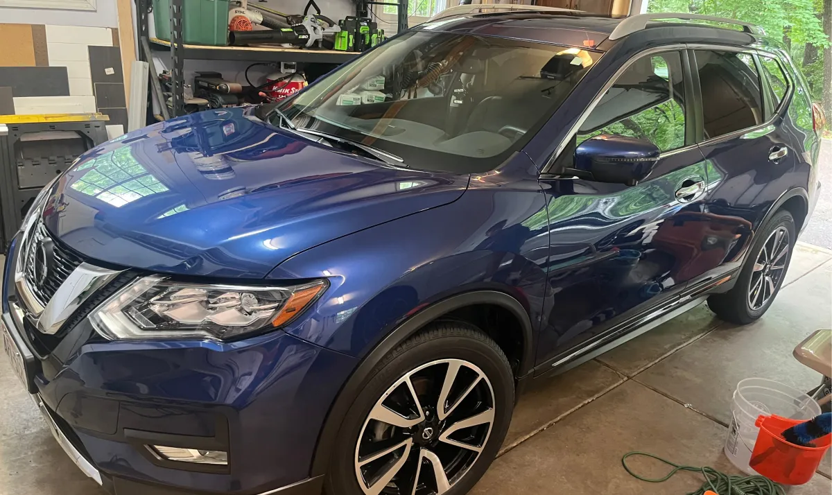 Blue Nissan Rogue close-up showing glossy finish after ceramic coating and paint correction in Eau Claire WI