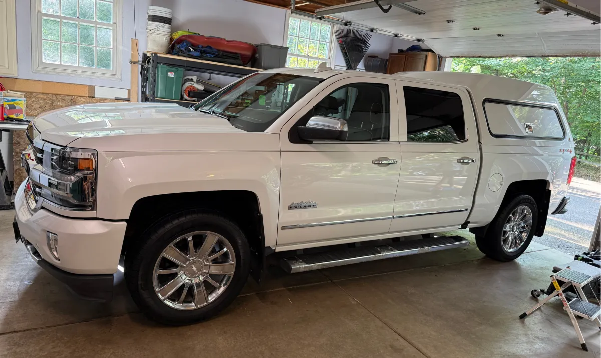 White Chevy Silverado High Country ceramic coated in Eau Claire WI for superior gloss, paint protection, and scratch resistance