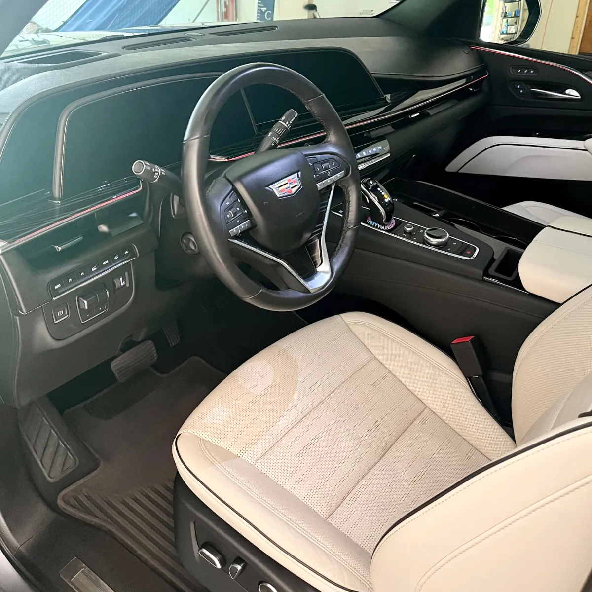 Cadillac interior after professional car detailing service with spotless seats and dashboard by Smoove Auto Detailing