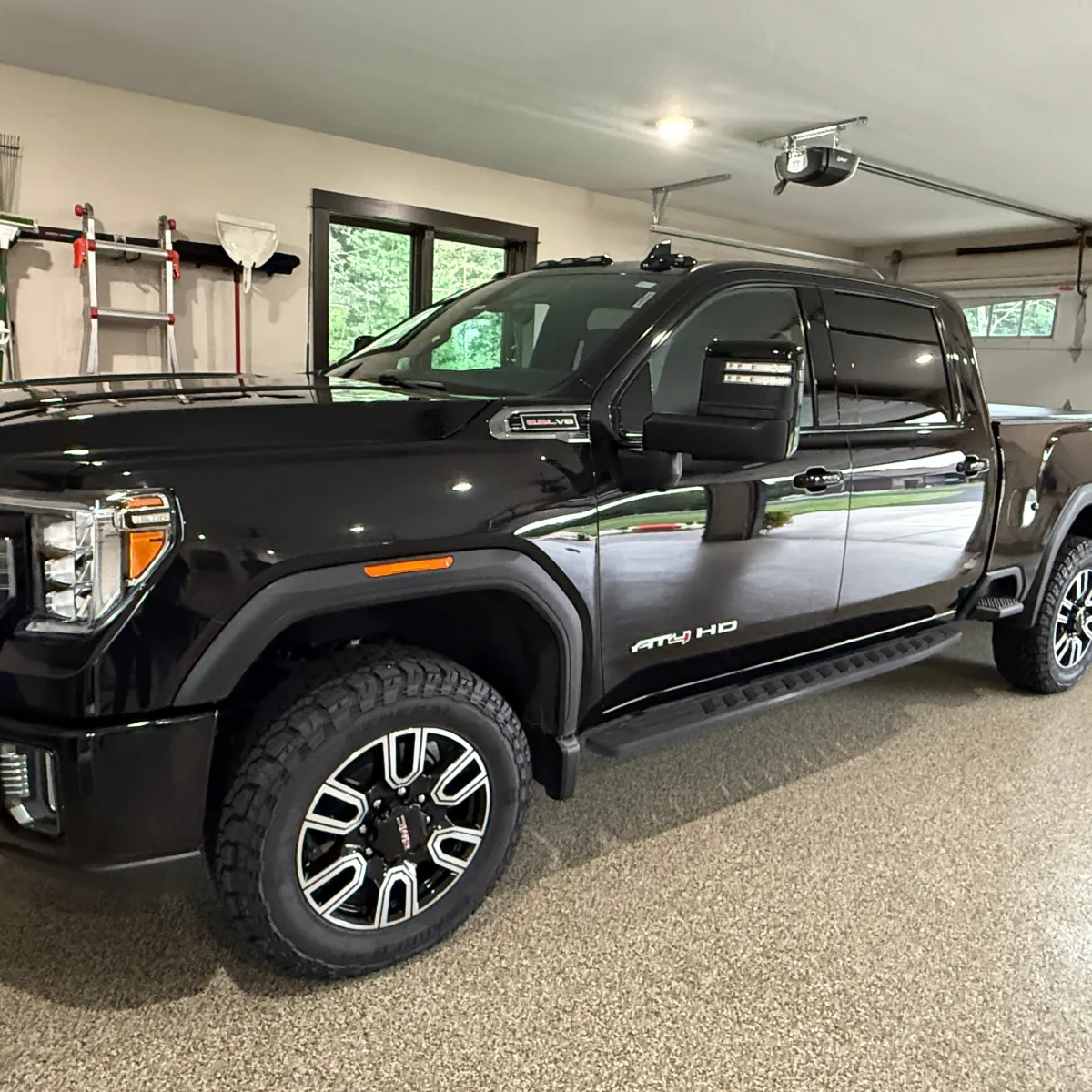 Black GMC pickup truck with glossy ceramic coating applied for durable paint protection and shine in Eau Claire