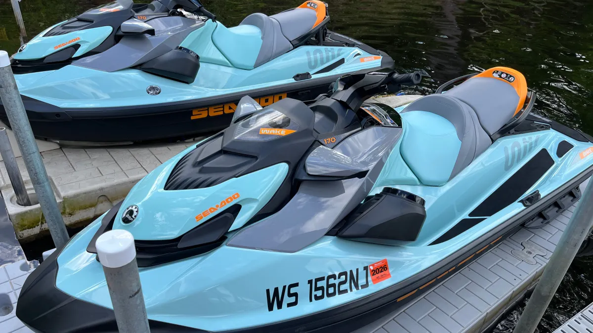 Two Seadoo jetskis, light blue and orange, after exterior detailing and wax service in Chippewa Falls WI for watercraft shine and protection