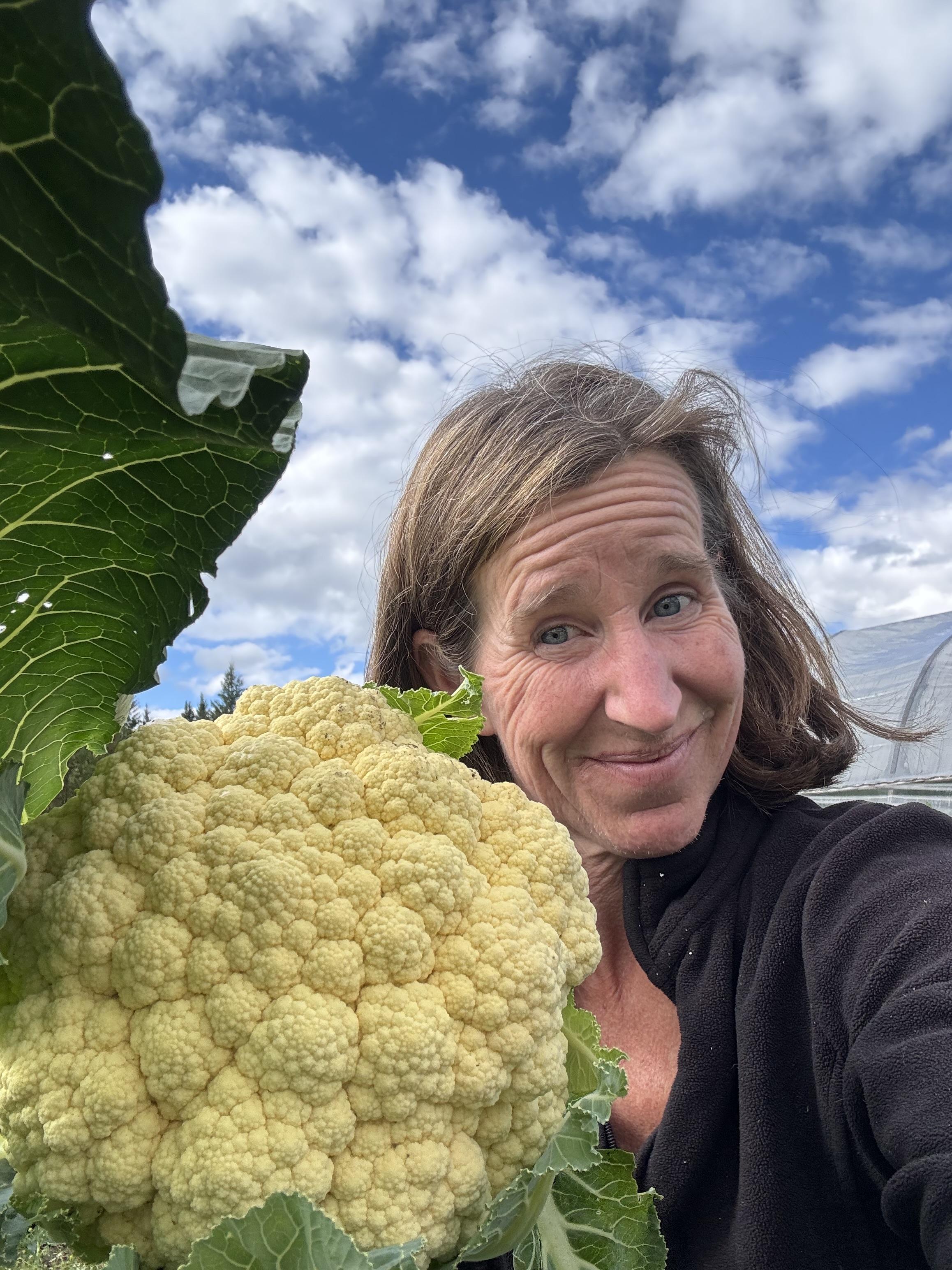 Erin Saunders smiling, wearing makeup on a town day, presenting a friendly and approachable demeanor.