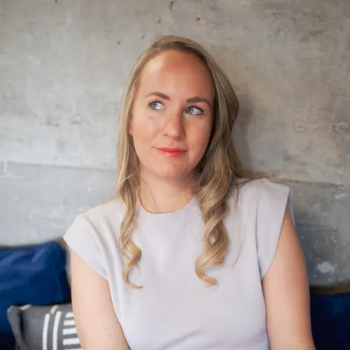 A woman sitting in front of a wall