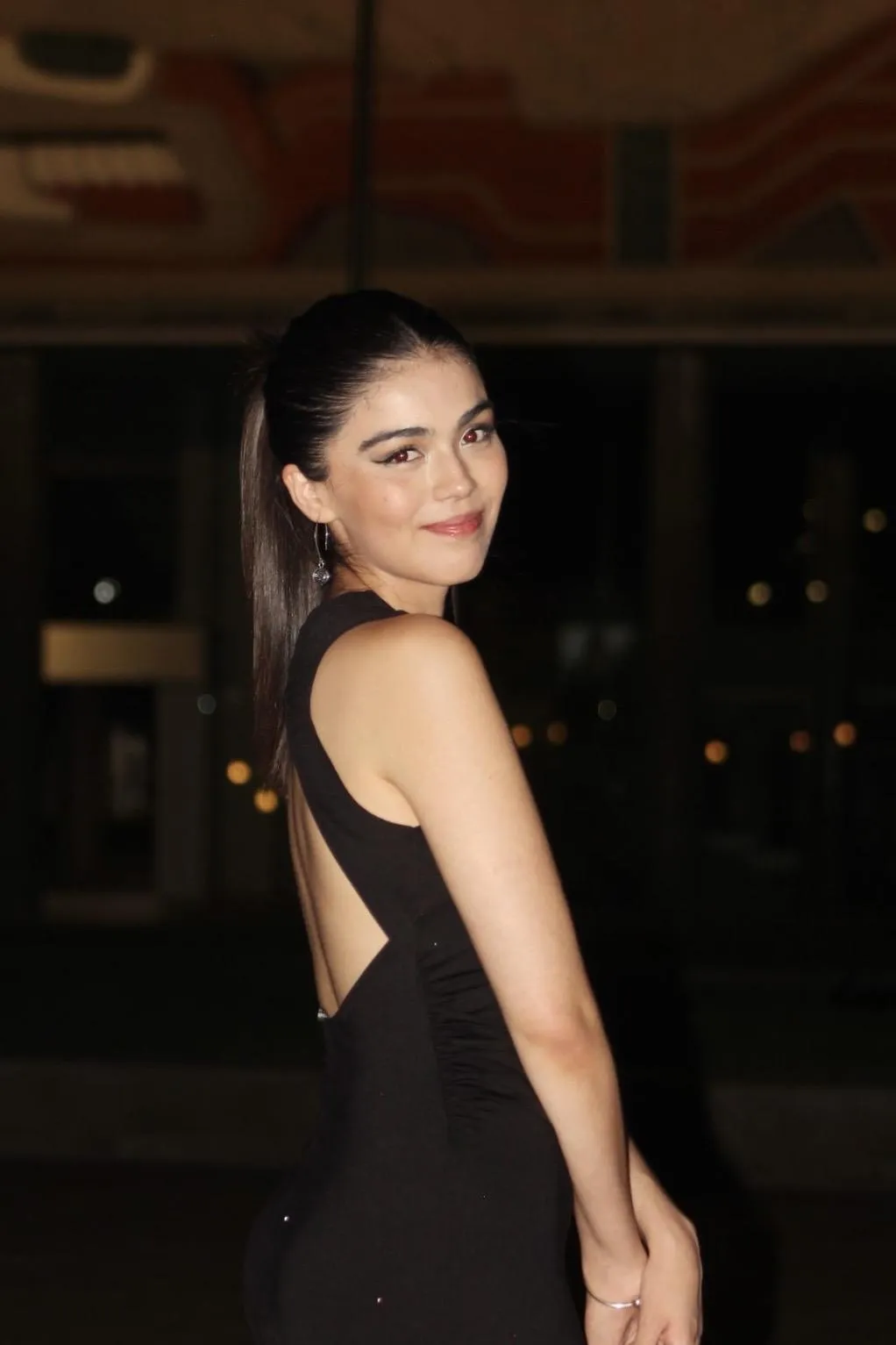 A woman with her arms open and looking upwards.