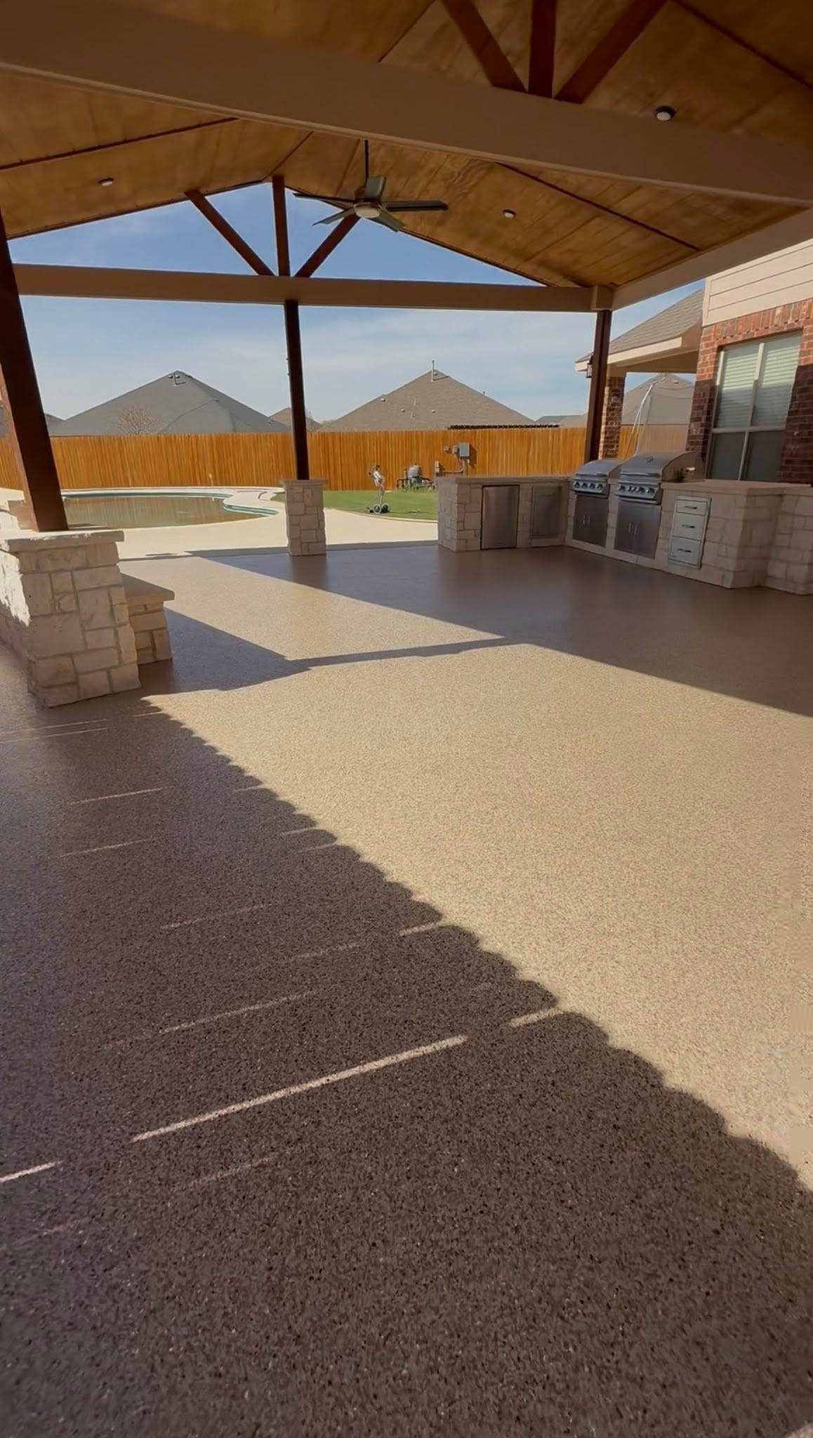 tan flake coating on a covered outdoor patio in Midland, TX